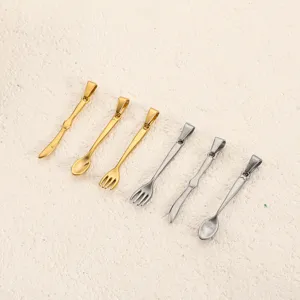 Detail of gold and silver stainless steel spoon fork knife pendants for DIY necklaces