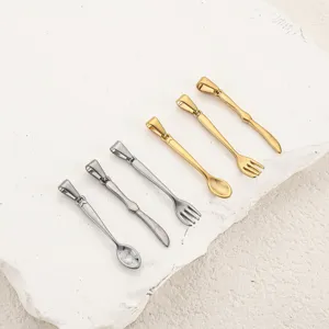 Detail view of miniature stainless steel spoon, fork, and knife necklace pendants