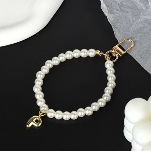 Detailed view of elegant white pearl chain with a gold-plated letter P charm and clasp
