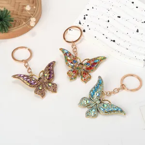 Detailed view of three colorful rhinestone butterfly keychains displayed on a white background