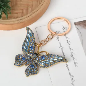 Close-up of a stunning gold alloy butterfly keychain with sparkling blue rhinestones