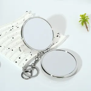 Macro view of portable mini round double-sided folding makeup mirror with keychain