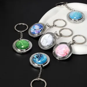 Sammlung faltbarer Handtaschenhalter mit bunten Marmormustern und silbernen Ringen