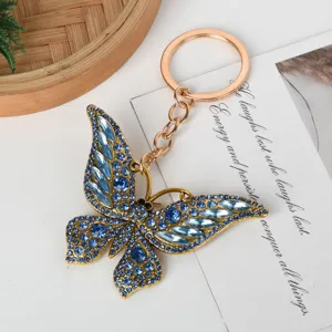 Detailed view of a sparkling blue rhinestone butterfly keychain with gold-tone alloy finish