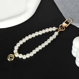 Elegant white pearl keychain charm featuring a gold-plated lobster clasp and donut pendant