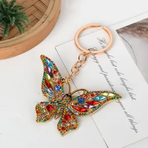 Close-up of a vibrant rhinestone butterfly keychain with colorful crystals and gold-tone alloy.