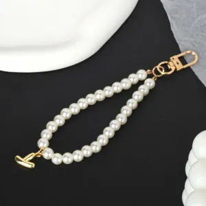 Detailed view of elegant white faux pearl keychain with a gold-plated letter I pendant