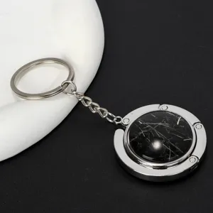 Faltbarer Taschenhalter für Tische mit elegantem Inlay in schwarzer Marmoroptik Design