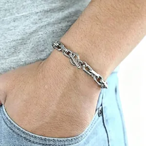 Close-up of polished silver stainless steel men's chain bracelet with toggle clasp
