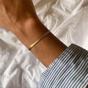 Detail shot of a minimalist gold-plated stainless steel snake chain bracelet on wrist
