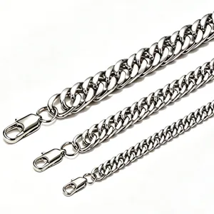 Close-up detail of silver stainless steel Cuban link chains in three different widths