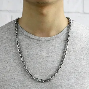 Detailed shot of a thick polished stainless steel oval link chain necklace for men