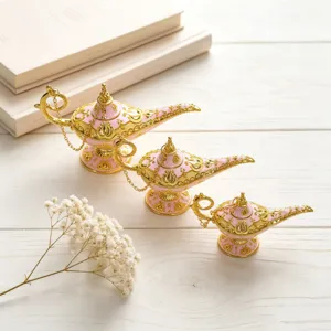 Detailed view of three pink and gold retro Aladdin wishing lamps in different sizes