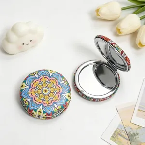 Macro view of vintage ethnic style portable makeup mirror featuring mandala patterns