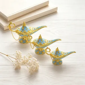 Detail view of three vintage ornate blue and gold Aladdin magic lamp figurines on a desk