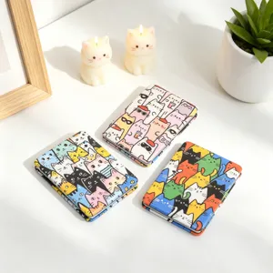 Macro view of portable folding makeup mirrors with colorful cute cartoon cat patterns