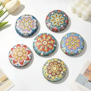 Detail view of 6 vintage ethnic round mirrors with vibrant mandala floral patterns