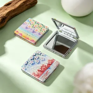 Macro view of portable oil painting folding mirrors with artistic floral patterns.