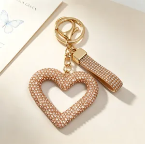 Close-up detail of a hollow heart-shaped keychain with sparkling full rhinestones.