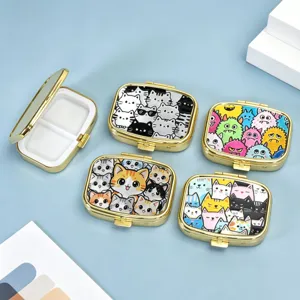 Detailed view of square 2-compartment pill boxes with various cute cartoon designs