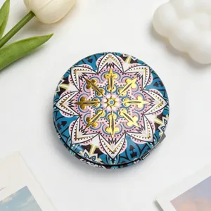 Detailed macro view of a portable vintage ethnic style makeup mirror with mandala pattern