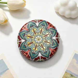 Detailed view of a vintage ethnic style round portable makeup mirror with mandala pattern