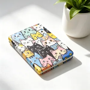 Close-up of a portable folding makeup mirror featuring a colorful cartoon cat pattern