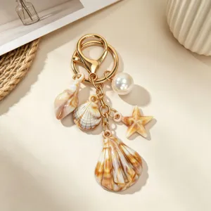 Close-up detail of ocean-themed keychain with brown sea shells and starfish charms