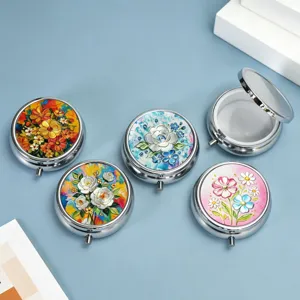 Detail view of small round pill boxes with decorative 3D floral lids