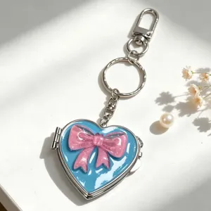 Herzförmiger Spiegel-Schlüsselanhänger mit einer rosa Schleife für elegante Handtaschen