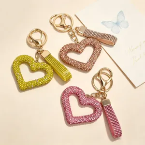 Detailed shot of three heart-shaped keychains with sparkling rhinestones in assorted colors