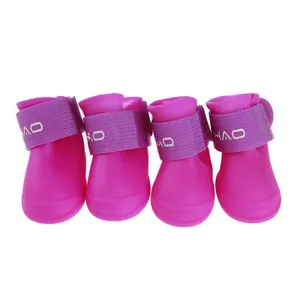 Close-up detail of pink waterproof silicone dog rain boots set, featuring secure purple strap.