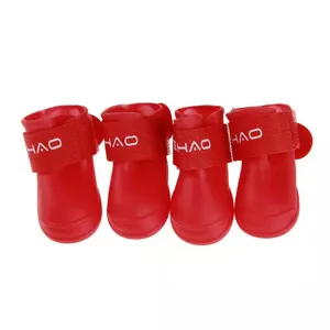 Waterproof red silicone dog boots, set of 4 pet rain shoes with adjustable straps.