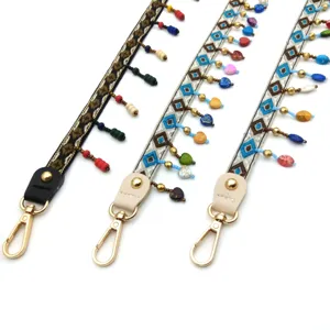 Close-up of ethnic style beaded shoulder straps with colorful embroidery and gold clasps
