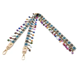 Bohemian ethnic embroidered bag strap with vibrant bead tassels and gold clasps