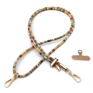 Detail of a retro multi-colored beaded phone lanyard with adjustable gold metal hardware