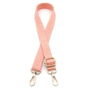Detail des verstellbaren rosa gewebten Schultergurts mit goldfarbenen Metallteilen
