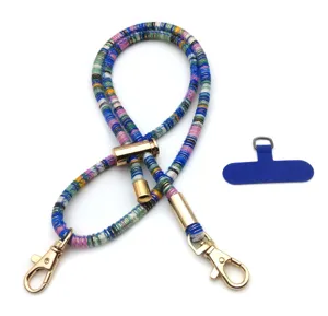 Detailed view of vintage colorful woven mobile phone lanyard with gold metal clips