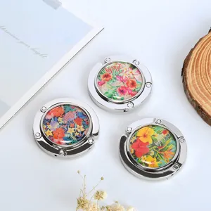 Set of three foldable desk bag hooks featuring vibrant tropical floral patterns and lucky text