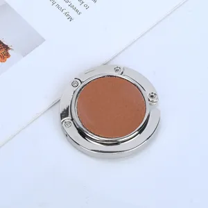 Compact silver portable bag hook with brown faux leather inlay for office desks