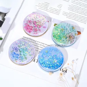 Four creative quicksand makeup mirrors with vibrant floral designs and sparkling glitter.