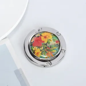 Close-up detail of foldable handbag hook with colorful hibiscus floral print