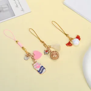 Detailed view of three cute alloy phone charms featuring cat paw and fox designs