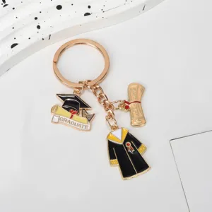 Detailed view of graduation themed keychain featuring academic gown and cap charms for students