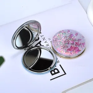 Detailed view of quicksand foldable makeup mirror with pink flower and sparkling glitter