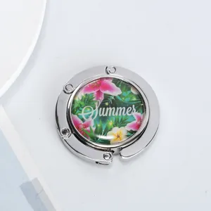 Detailed view of portable foldable purse hook featuring a vibrant floral Summer design