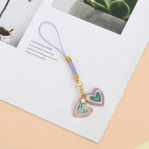 Close-up of a cute purple phone strap featuring colorful enamel heart charms and gold accents