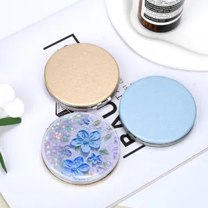 Detail view of portable quicksand folding mirrors in glitter purple and solid colors