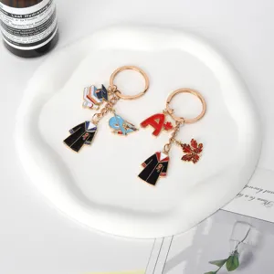 Close-up of graduation gown and A+ grade charms on gold-tone keychains for gifts.