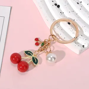 Charming red resin cherry keychain with white pearl accent and elegant gold-tone ring